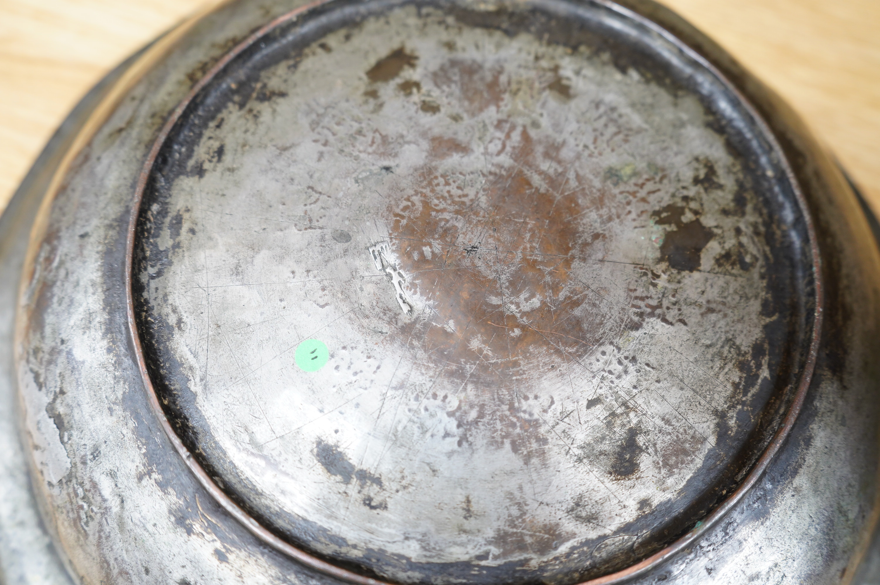 A Safavid tinned copper bowl engraved with a goat and flowers, 32cm diameter. Condition - fair